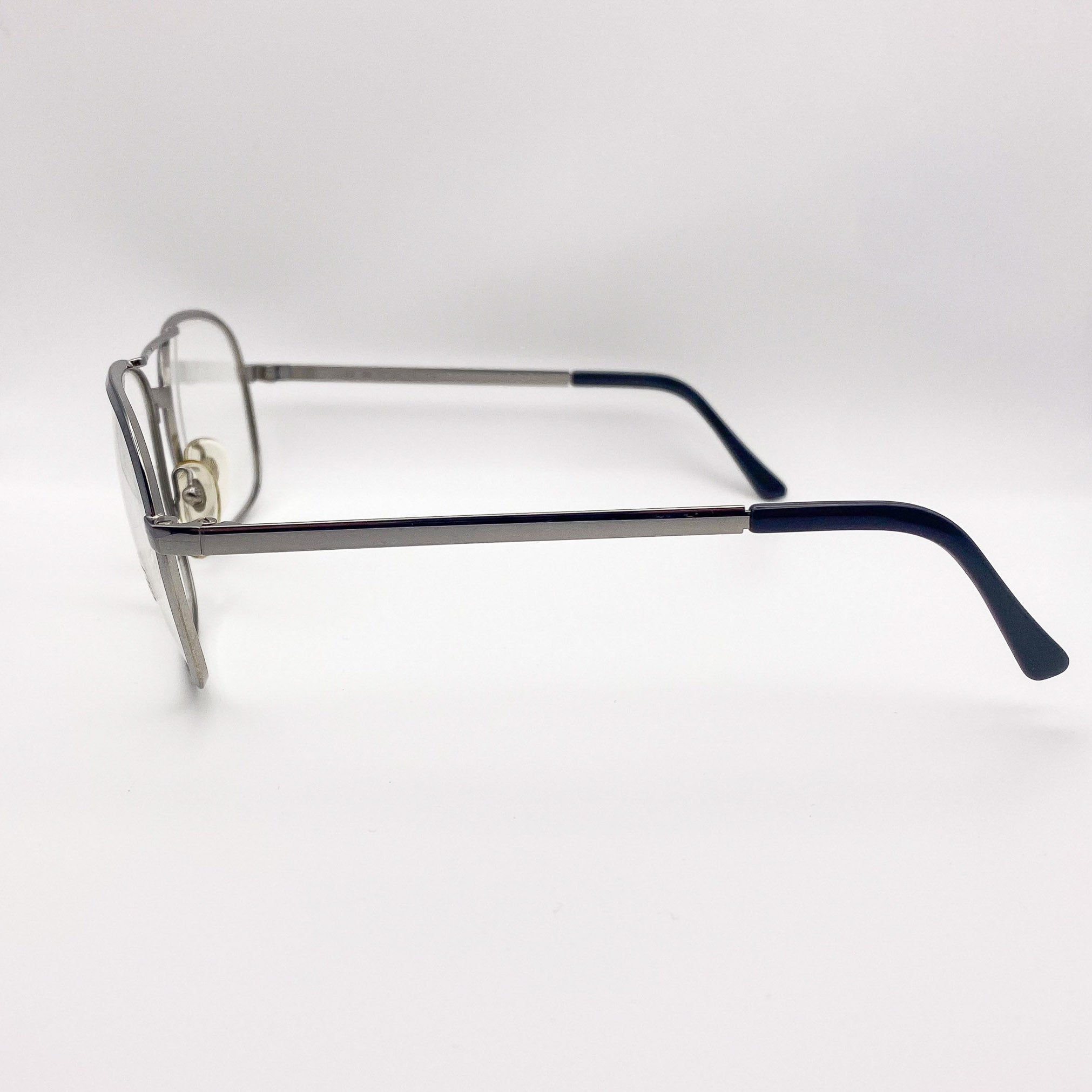 Eyeglasses with a silver frame and black arms on a white background