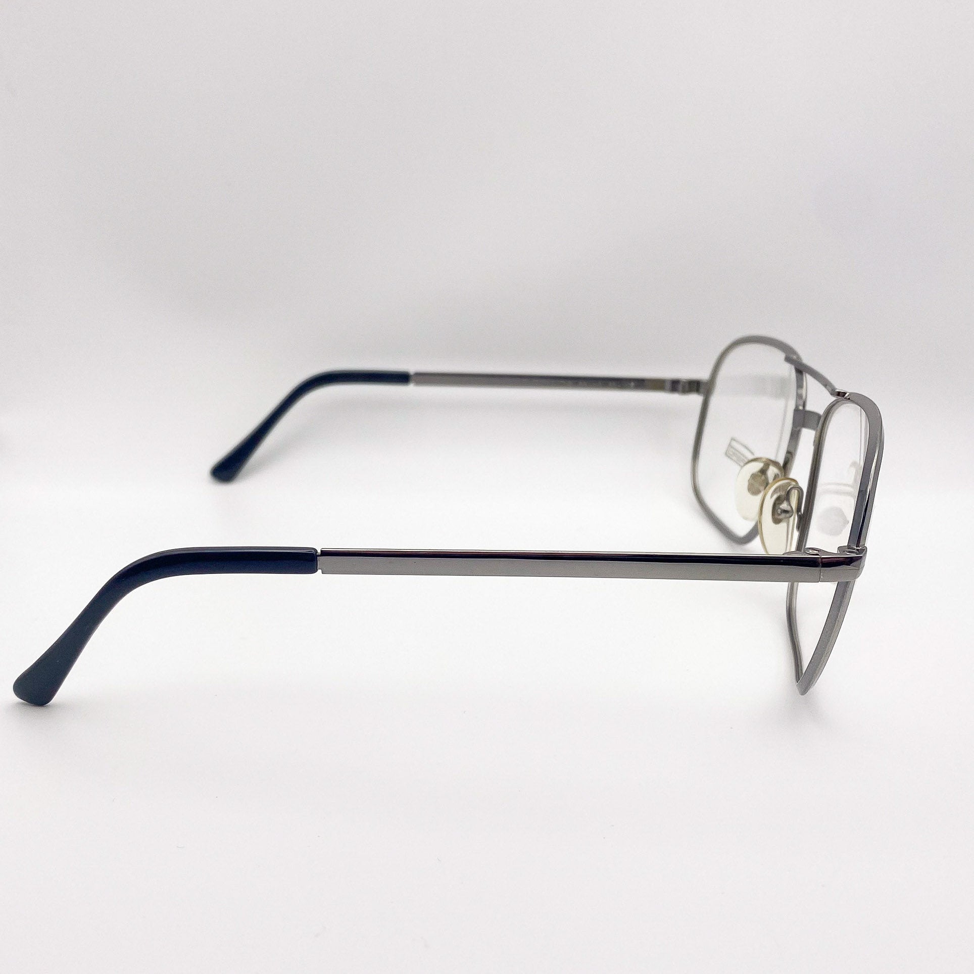 Silver aviators with black arms on a white background