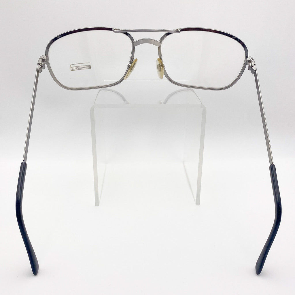 Eyeglasses with metal frame and black accents on a white background