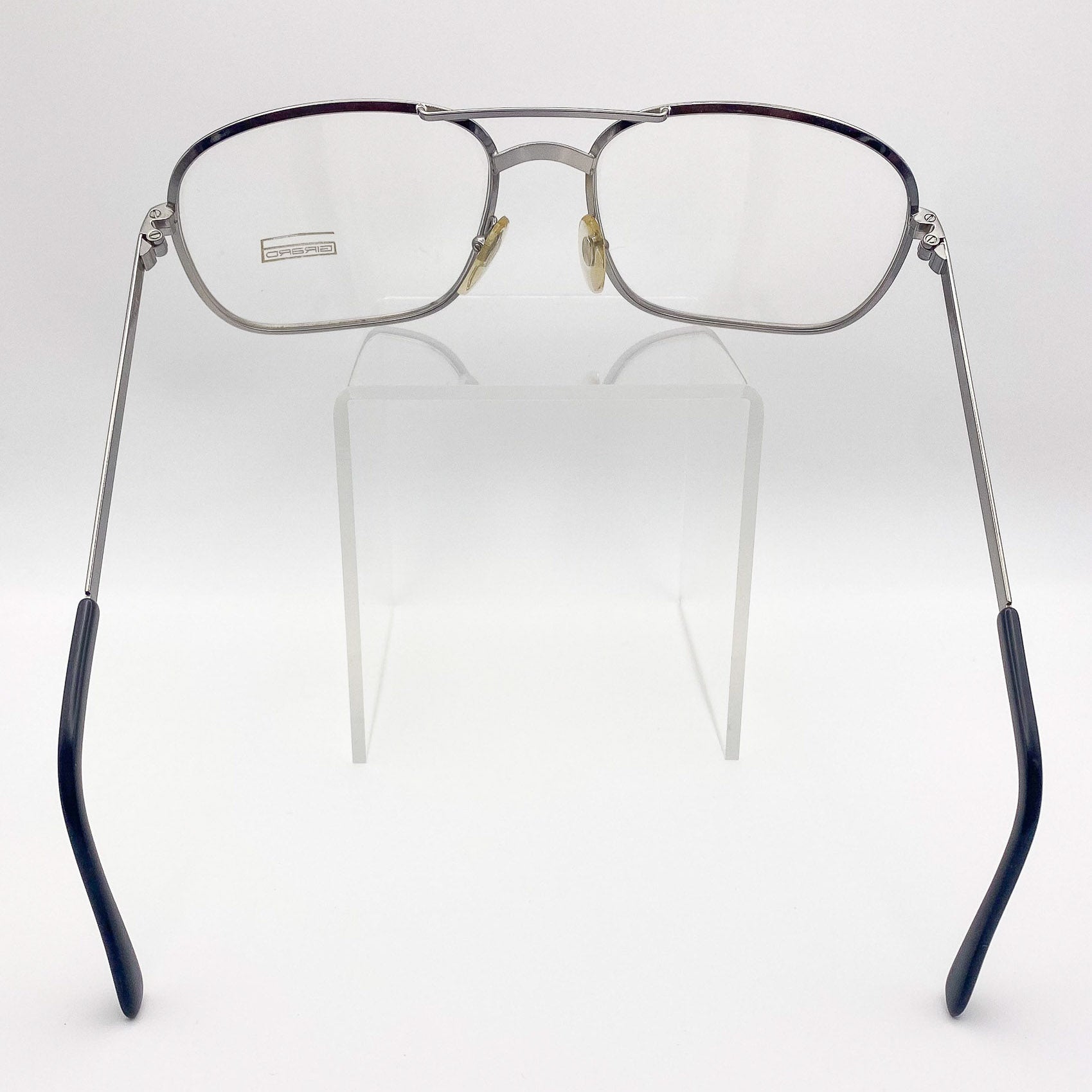 Eyeglasses with metal frame and black accents on a white background
