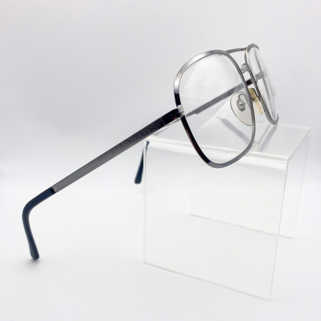 Vintage eyeglasses with a silver frame on a white background