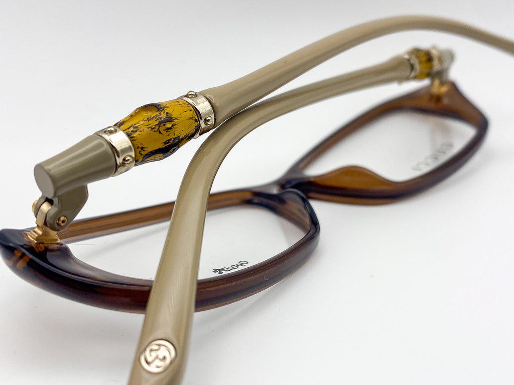 Eyeglasses with tortoiseshell frame and gold accents on a white background