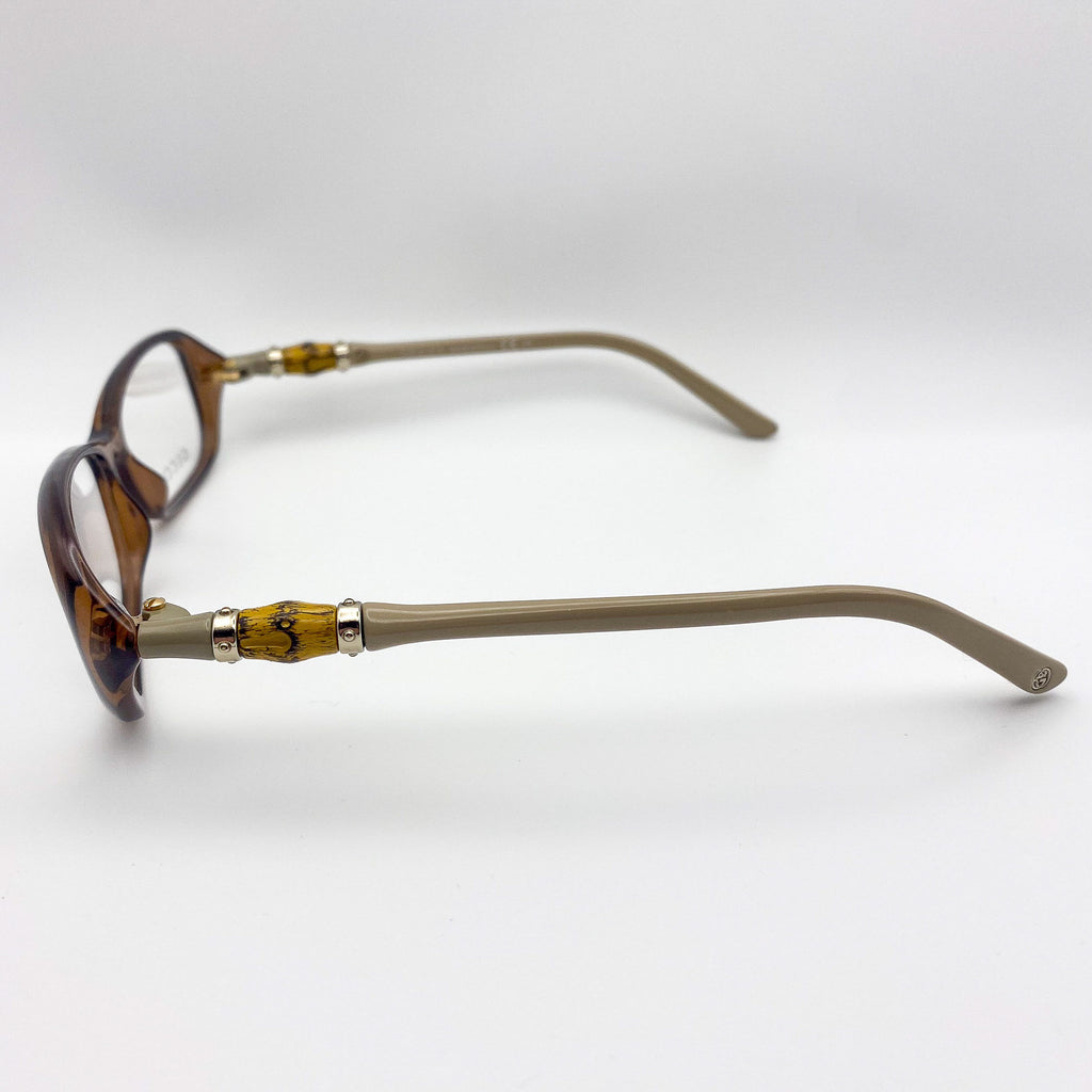 Eyeglasses with a tortoiseshell frame and beige arms on a white background