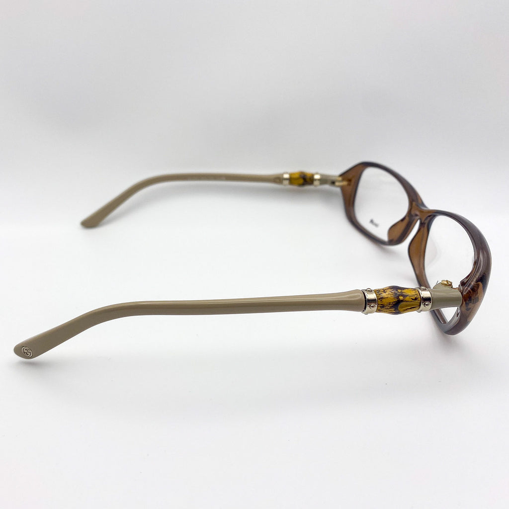 Pair of rectangular eyeglasses with tortoiseshell frame and beige arms on a white background