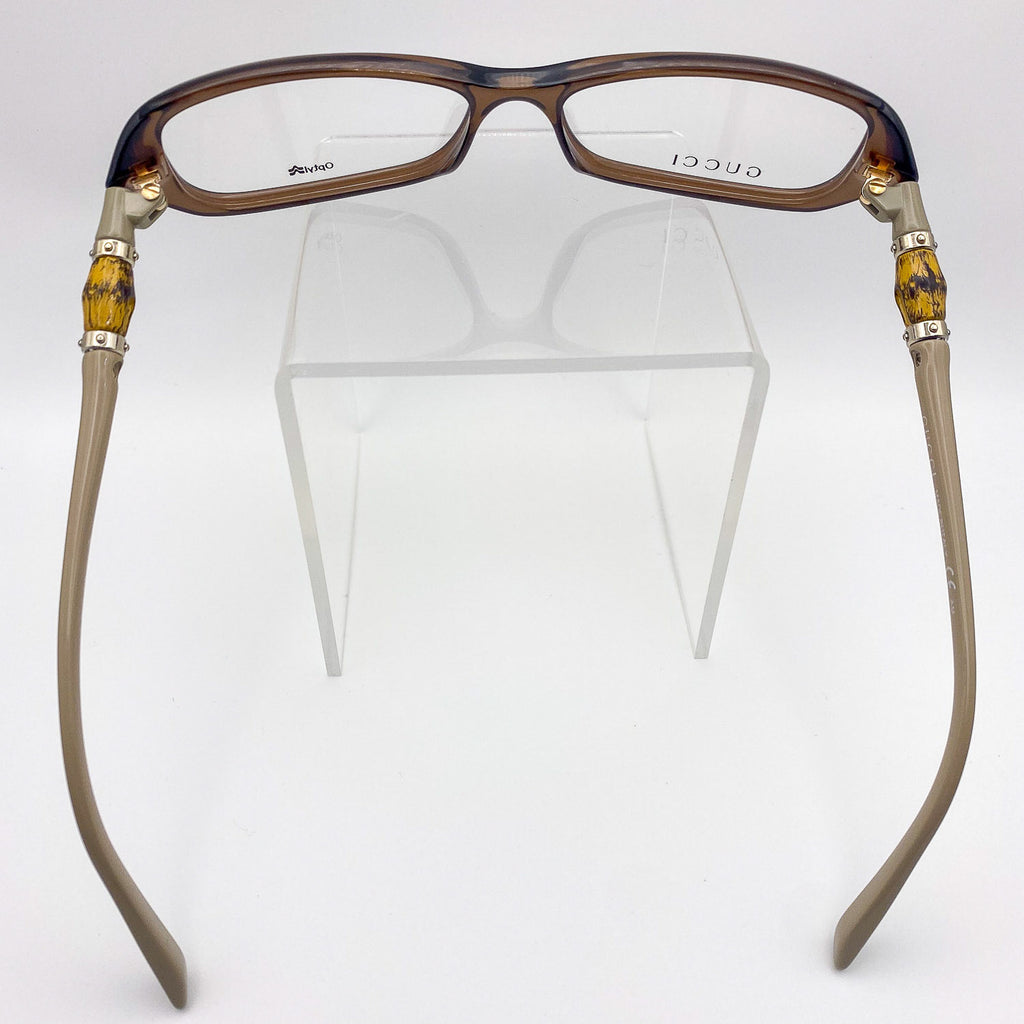 Gucci eyeglasses with tortoiseshell and beige frame on a white background
