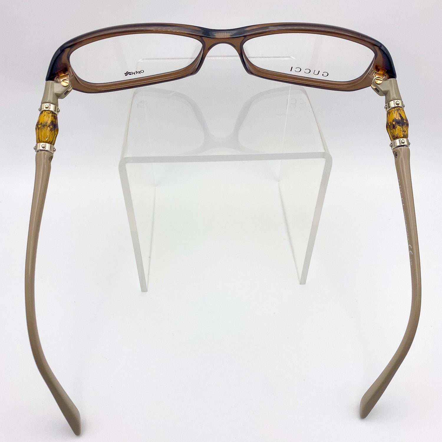 Gucci eyeglasses with tortoiseshell and beige frame on a white background