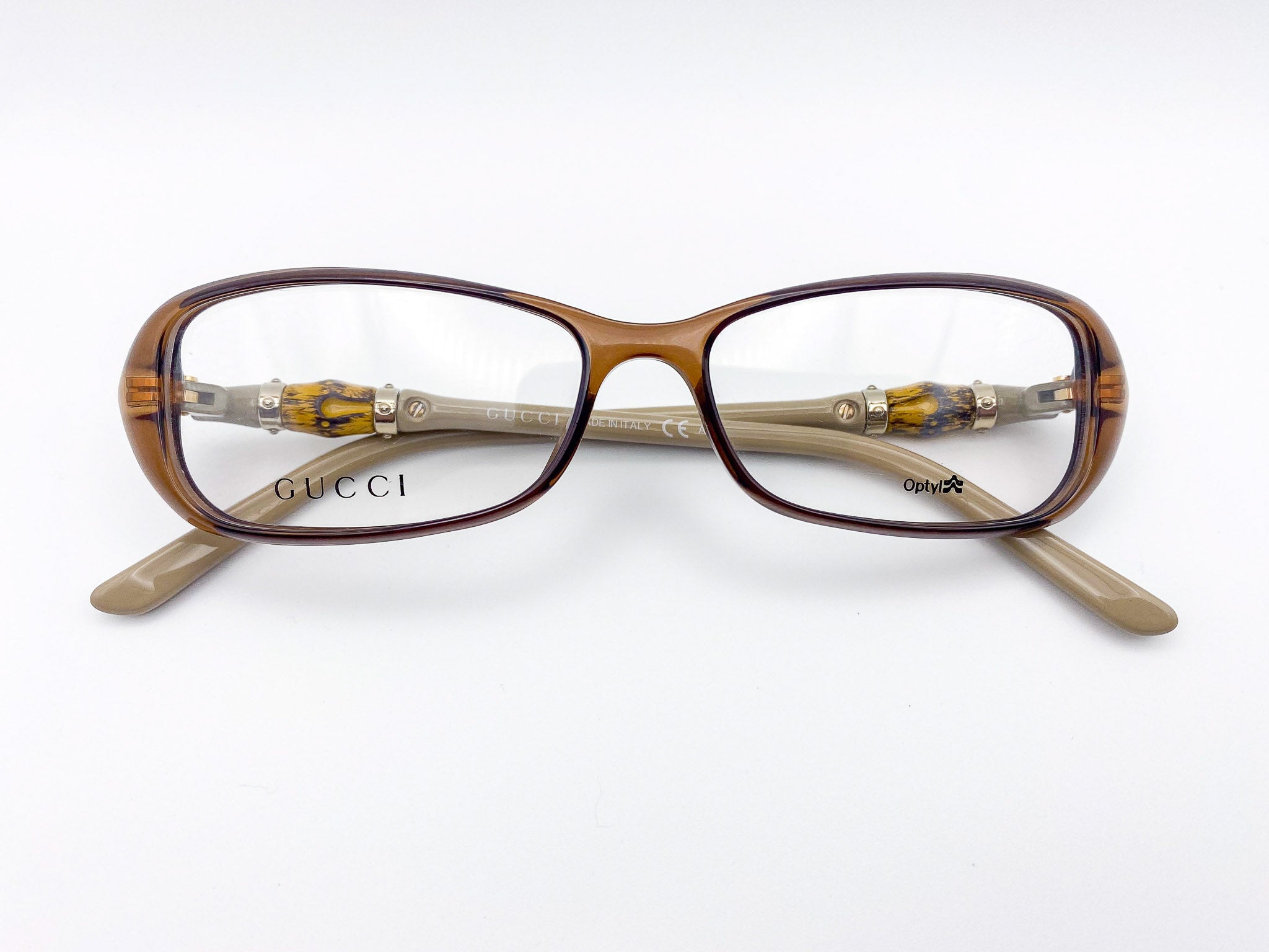 2000s era brown Gucci eyeglasses on a white background