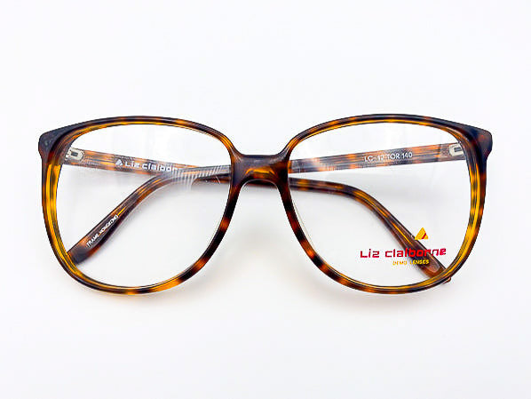 1980s tortoiseshell eyeglasses with 'Liz Claiborne' branding on a white background