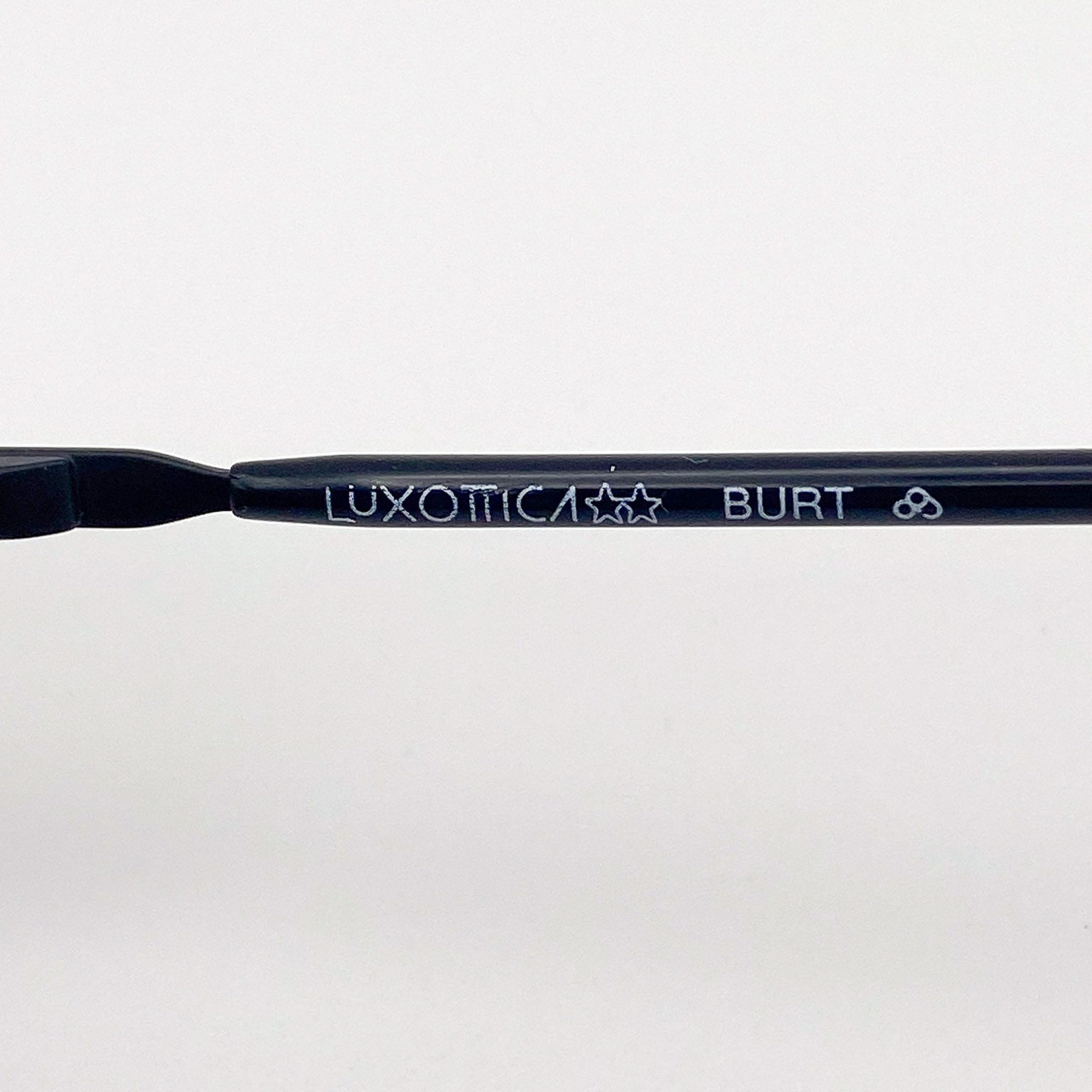 Eyeglass frame with 'Luxottica Burt' branding on a white background