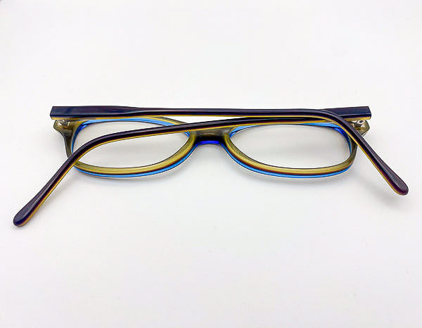 Two-toned eyeglasses with a blue and olive green frame on a white background