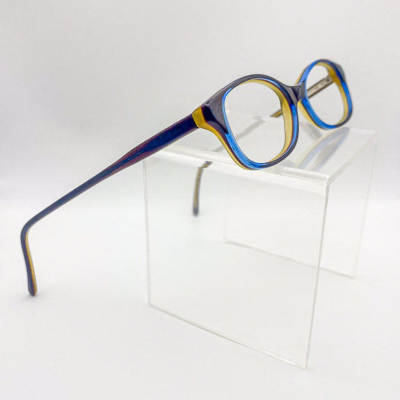 Blue, brown, and olive green eyeglasses on a white background