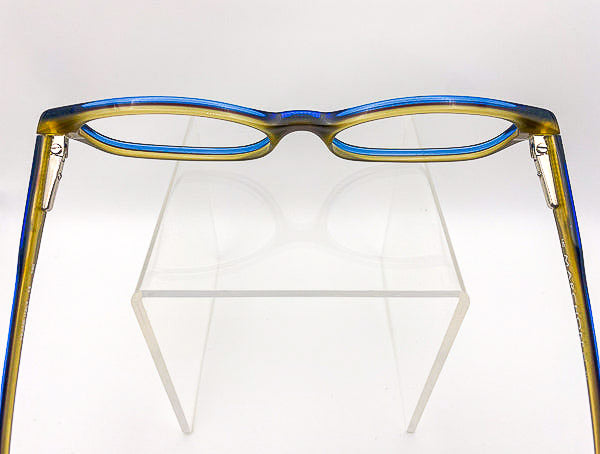 Vintage Marchon two-toned blue and olive green eyeglasses on a white background