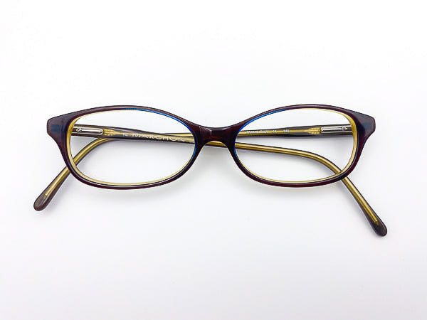 Vintage 2000s Marchon eyeglasses with a brown and green frame on a white background