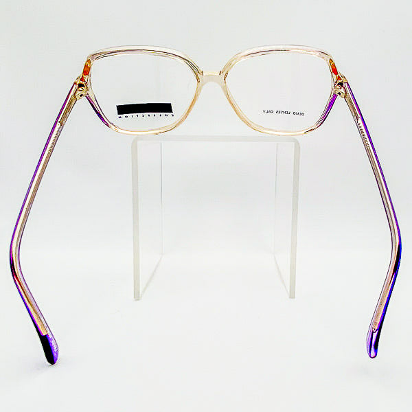 Eyeglasses with a gold and purple frame on a white background