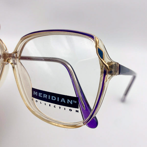 Vintage eyeglasses with 'Meridian Collection' label on a light gray background