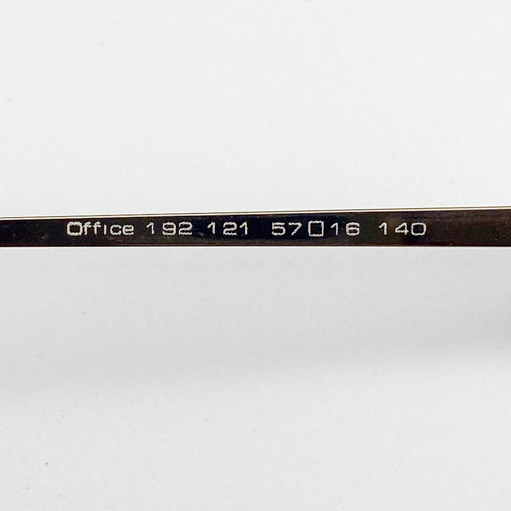 Close-up of an eyeglass frame with 'Office' text on a white background