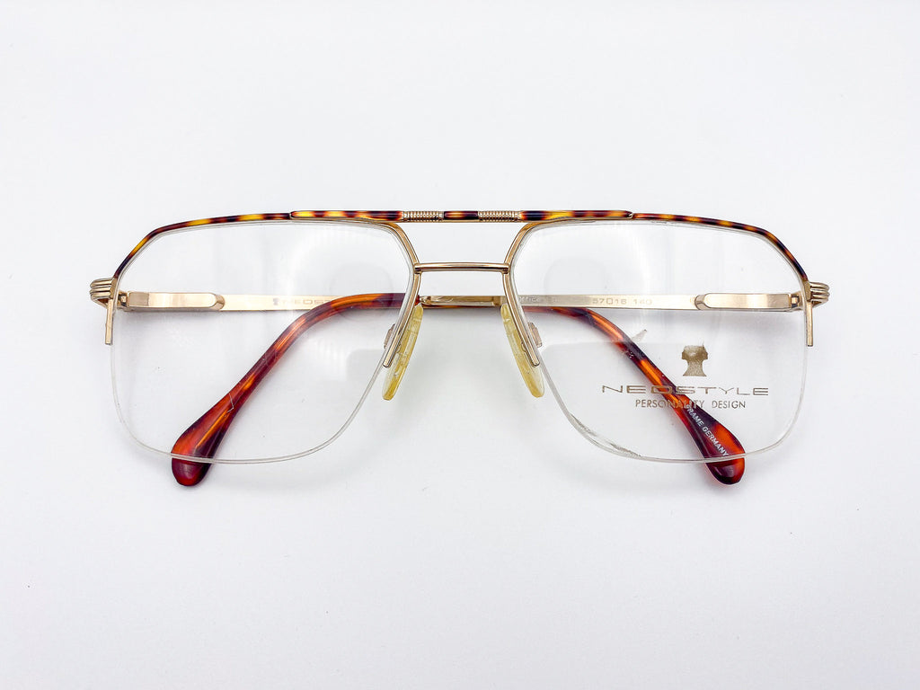 Vintage Neostyle gold and tortoiseshell aviator eyeglasses on a white background