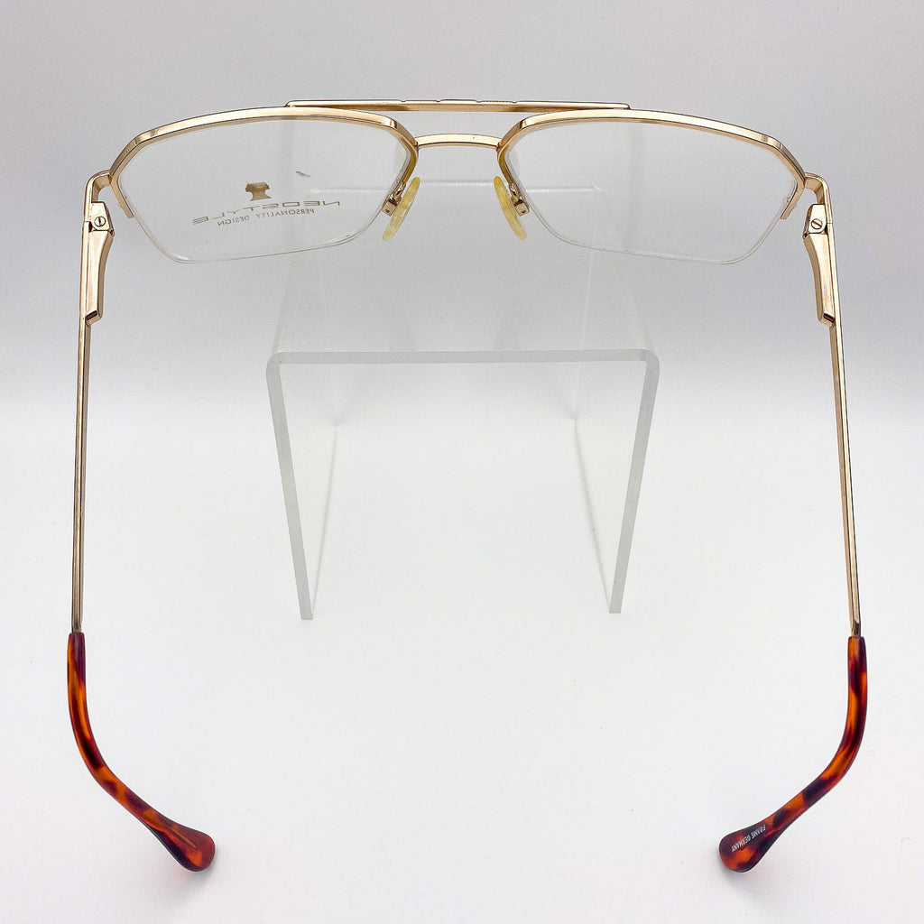 Gold-framed eyeglasses with tortoiseshell arms on a white background