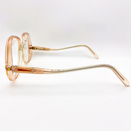 Peach and gold-framed eyeglasses on a white background