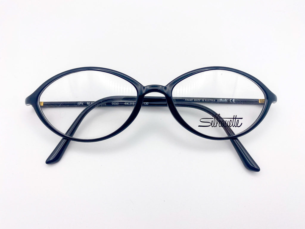 Vintage black eyeglasses with 'Silhouette' branding on a white background