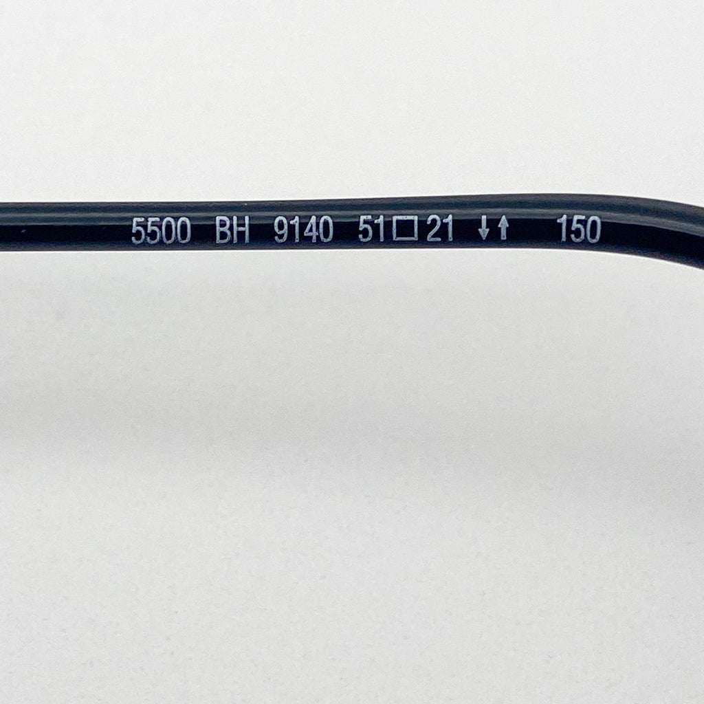 Close-up of a black eyeglass frame with text on a white background