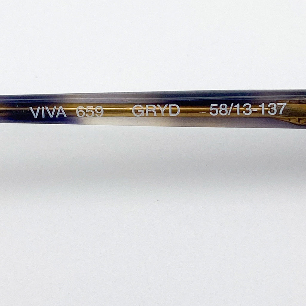 Close-up of an eyeglass stem with branding and model information on a white background