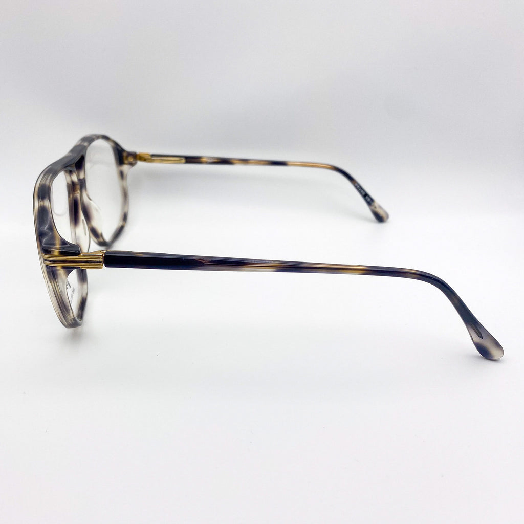 Vintage tortoiseshell eyeglasses on a light gray background