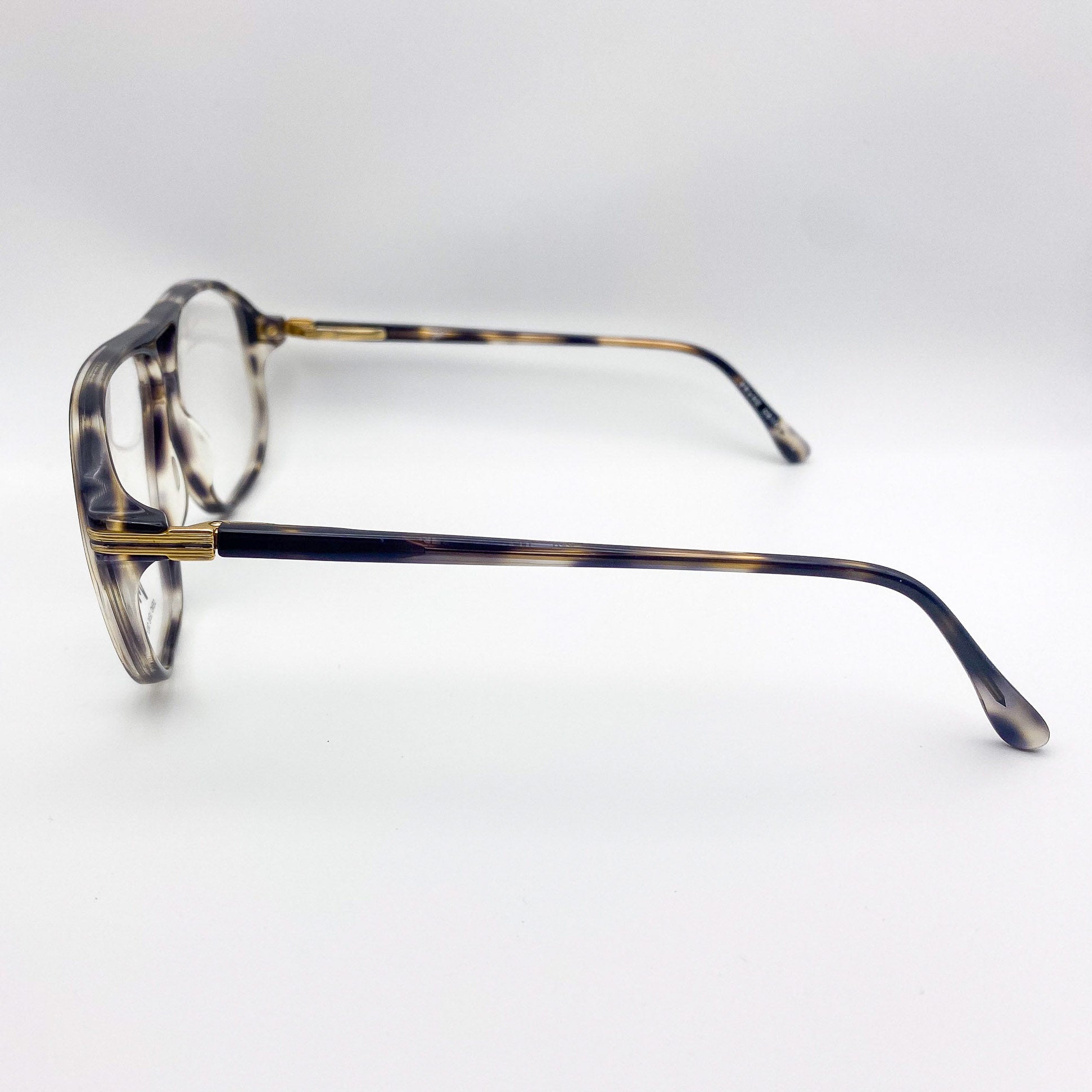 Vintage tortoiseshell eyeglasses on a light gray background