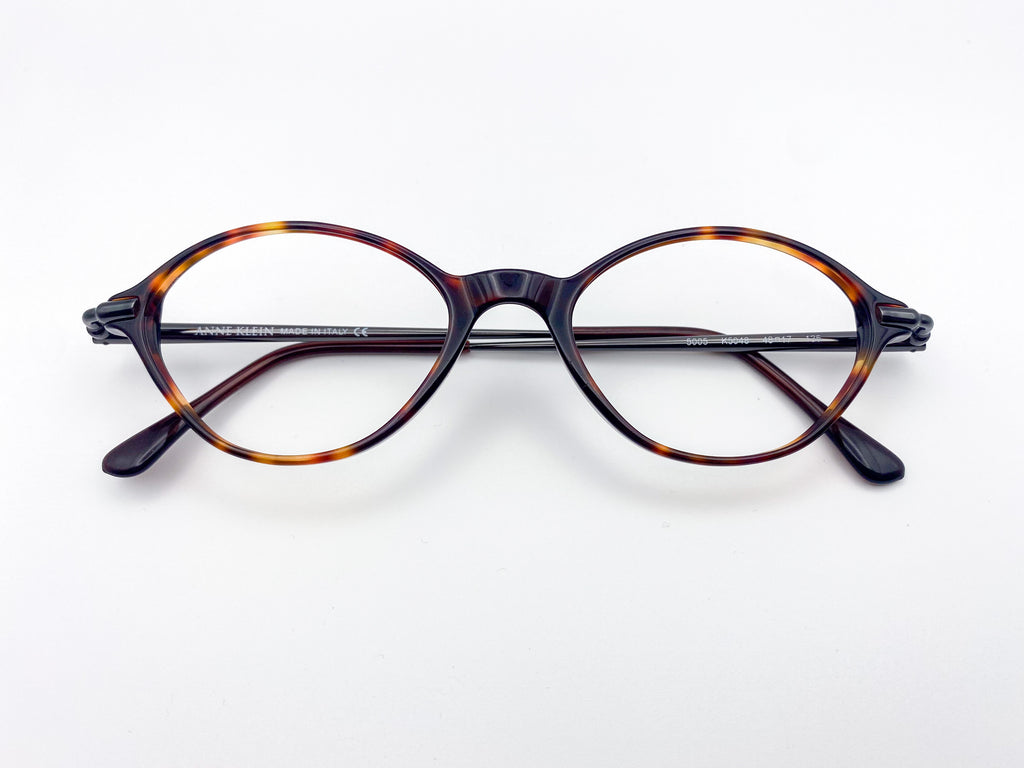 Anne Klein tortoiseshell eyeglasses on a white background